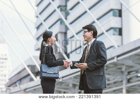 Modern Business people deal.partners shake hands, standing in front of his office. city background. handshake concept