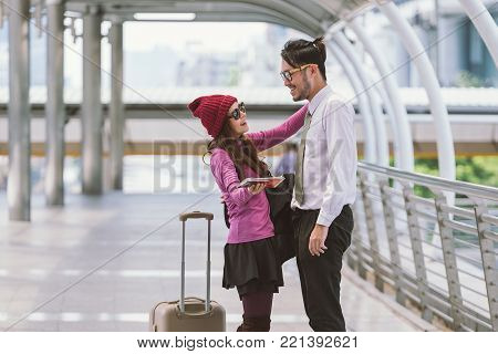 Welcoming embrace. Young loving couple hugging in the airport terminal.