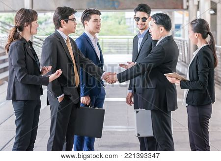 Group of Business people shaking hands,Teamwork finishing up a meeting partners greeting each other after signing contract and go Seminar.
