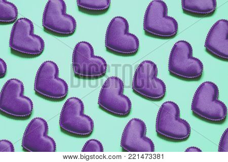 Pattern made of ultra violet hearts on blue background. Heart in isometric style. Valentine's card. May be use for wrapping paper.