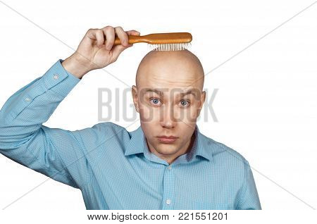 White balding man combing his bald head comb