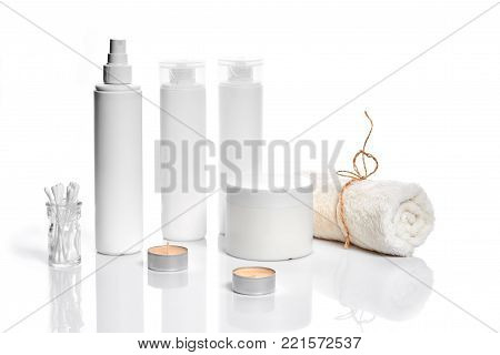 Set of cosmetic products in white containers on light background. Still life. Copy space. Place for your brand