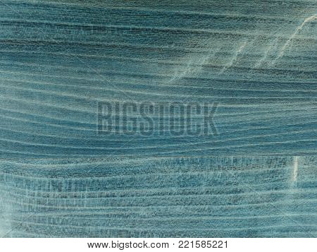 The old table top, worn out stained  navy blue with shades. Fine structure of cherry wood saturated with blue mordant
