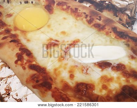 Adjarian khachapuri, open bread stuffed with cheese and egg yolk. Khachapuri is a traditional dish of Georgian cuisine.