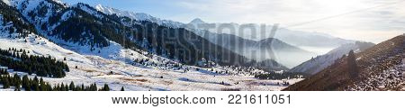 Foggy sunset in the Kazakhstan mountains. Winter landscape
