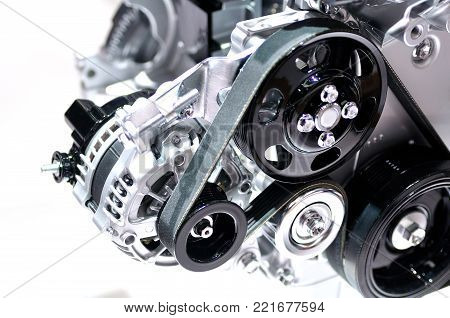 Car alternator with drive belt isolated on white background.