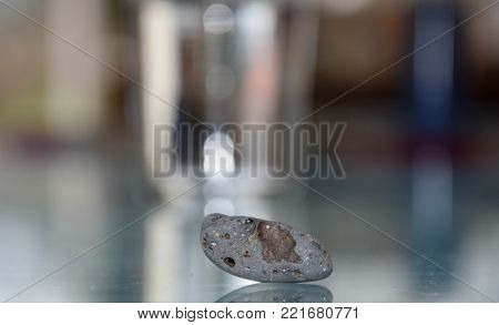 small grey stone with abstract background, minimalism with blurry background
