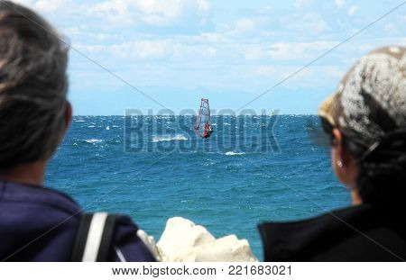 Far distance view on sailboards on summer day