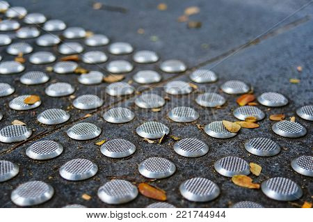 Metal tactile paving tiles for the blind. Care for the disabled