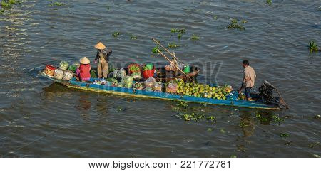 Soc Trang, Vietnam - Feb 2, 2016. People with boats at a floating market on Mekong River in Soc Trang, Vietnam. Mekong is the longest river in Southeast Asia, the 7th longest in Asia.
