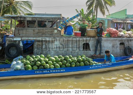 Soc Trang, Vietnam - Feb 2, 2016. People with boats at a floating market on Mekong River in Soc Trang, Vietnam. Mekong is the longest river in Southeast Asia, the 7th longest in Asia.