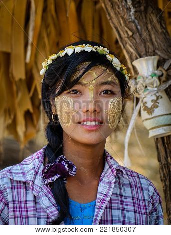 Bagan, Myanmar - Feb 22, 2016. A Burmese woman with thanaka paste on her face in Bagan, Myanmar. Thanaka is a yellowish-white cosmetic paste made from ground bark.
