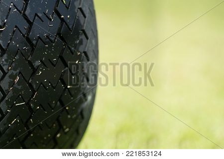 Close up wheel of Buggy car in a golf course.