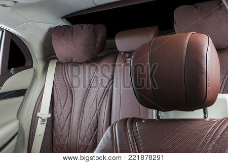 Modern Luxury car inside. Interior of prestige modern car. Comfortable leather seats. Red and white perforated leather. Back passenger seats.  Modern car interior details