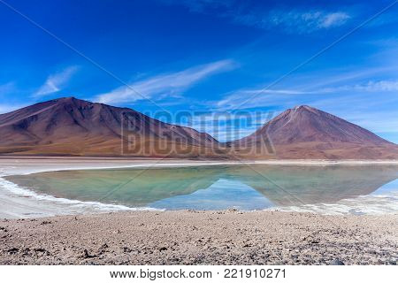 The natural colors of the green lagoon in the Siloli desert near the border of Chile and the Uyuni Salt Flat in Bolivia