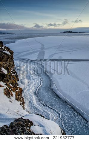 View above big beautiful frozen lake and mountain in winter, Baikal lake, Russia, Siberia