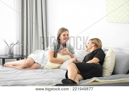 Young chambermaids in uniform resting indoors