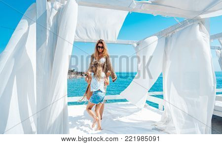 Mom and daughter spend time together on the beach bed