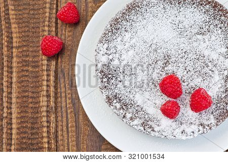 Chocolate Sticky Brownie Cake, Swedish Dessert Kladdkaka, On The Plate, Garnished With Icing Sugar A