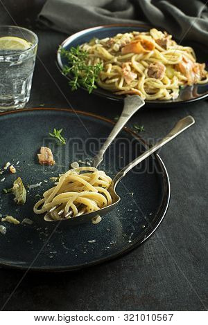 Eating Fresh Pasta With Smoked Salmon In Cream Sauce. Healthy Vegetarian Meal