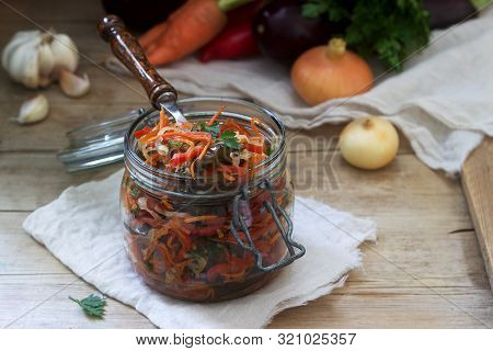 Vegetable Salad Of Eggplant, Sweet Pepper, Carrots And Onions And Vegetables For Salad On A Wooden B
