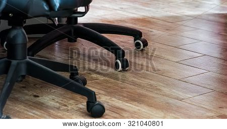 Detail Of Two Office Chairs Casters Wheels On A Wooden Floor