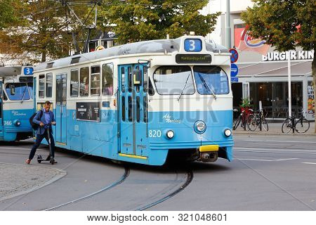 Gothenburg, Sweden - September 2, 2019: Tram Of Class M29 And Man On An Electric Scooter.