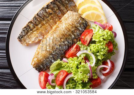 Diet Healthy Food Grilled Mackerel Fillet With Lemon And Fresh Vegetable Salad Close-up On A Plate.