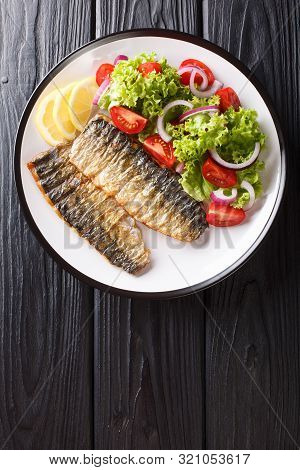 Spicy Grilled Mackerel Fillet With Lemon And Fresh Vegetable Salad Close-up On A Plate. Vertical Top