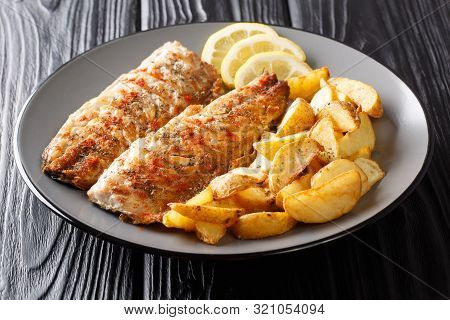 Grilled Fish Mackerel Fillet With A Side Dish Of Fried Potatoes Close-up On A Plate. Horizontal