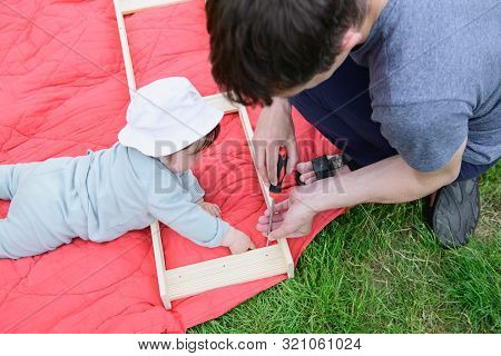 Girl Feeds A Little Pig. In A Green Meadow. The Concept Of Sustainability, Love Of Nature, Respect F