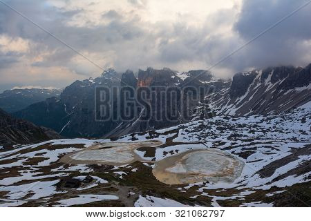 Lakes Of The Piani Covered With Ice In Spring. Tre Cimе, Italy