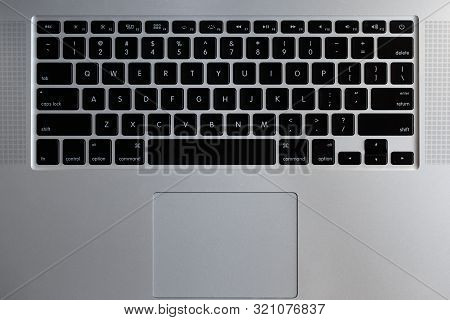 Silver Laptop Keyboard With Black Buttons Close-up Top View