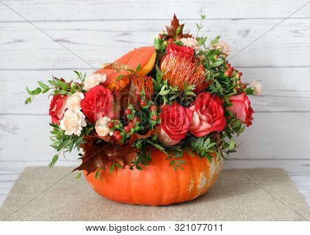 Beautiful Flower Arrangement In A Pumpkin. Autumn Floral Pumpkin Background. Pumpkin With Flowers On