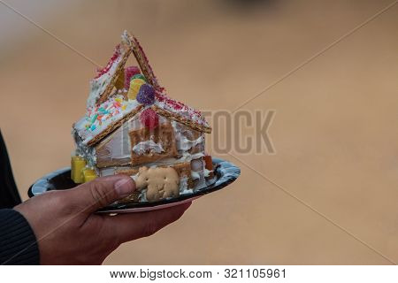 Man Holds Handmade Gingerbread House At Christmas Festival Contest
