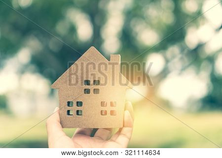 Copyspace Model Of A Little House That Woman Holds It Background.
