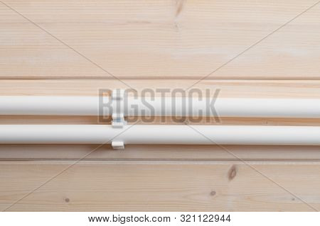 Two White Water Pipes Mounted On A Wall, Close-up