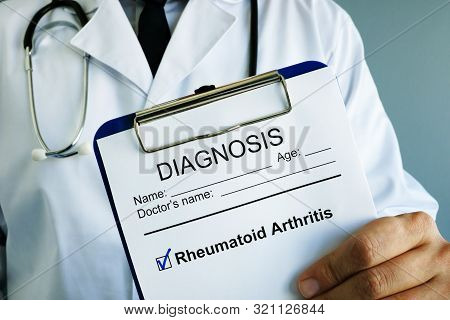 Doctor Holding Clipboard With Diagnosis Rheumatoid Arthritis.