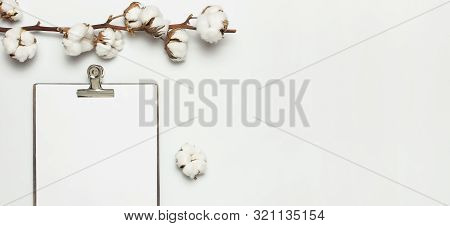 Blank White Paper With Folder And Metal Clothespin, Cotton Branch On Gray Background Top View Flat L