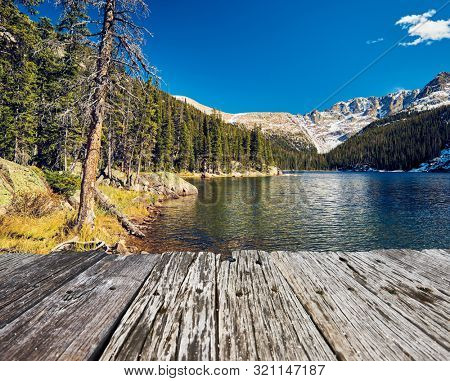 Lake Verna with rocks and mountains around at autumn. Rocky Mountain National Park in Colorado, USA. 