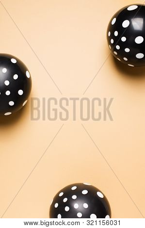 Halloween Party Flat Lay With Black Balloon And Confetti On Biege Background, Holiday And Black Frid