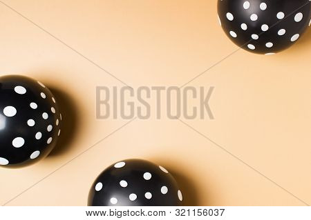 Halloween Party Flat Lay With Black Balloon And Confetti On Biege Background, Holiday And Black Frid