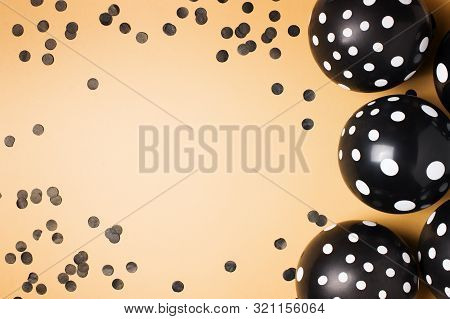 Halloween Party Flat Lay With Black Balloon And Confetti On Biege Background, Holiday And Black Frid