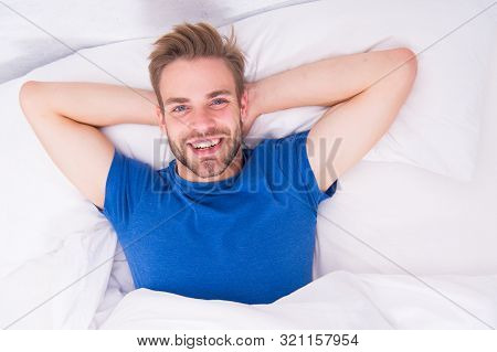 New Smile, New Day. Happy Man Awaken In Bed. Handsome Caucasian Man With Happy Smile Relaxing In The