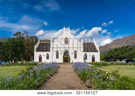 Historic Church In Cape Dutch Architectural Style On The Main Street In Franschhoek, In The Franschh