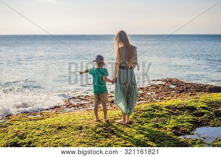 Mother And Son Tourists On Pantai Tegal Wangi Beach, Bali Island, Indonesia. Bali Travel Concept. Tr