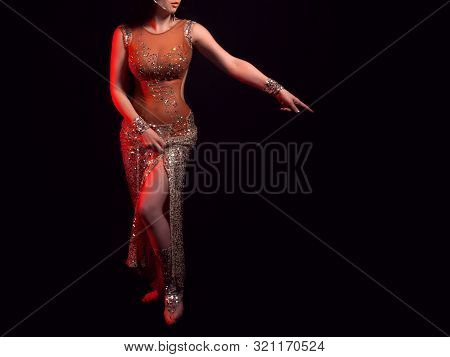 The Body Of A Beautiful Girl In A Beaded Costume For Belly Dance On A Black Background. A Sexy Woman