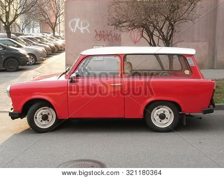 Prague, Czech Republic - Circa March 2015: Red Trabant Car Parked In A Street Of The City Centre.