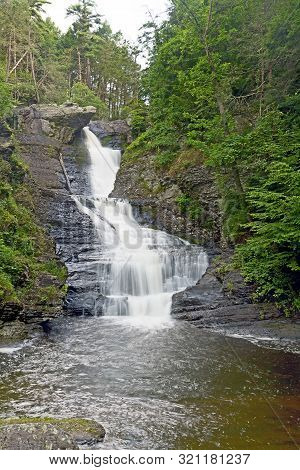 Tall Waterfall In Pennsylvania In Summer With Silky Flowing Water.