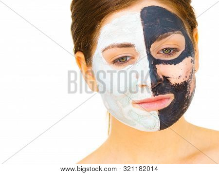 Woman With Clay Carbo Black Mask On One Half Face And White Mud On Second Half. Girl Removing Cosmet